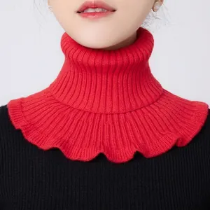 Detail of red knit turtleneck neck warmer showing soft texture and scalloped wavy edges