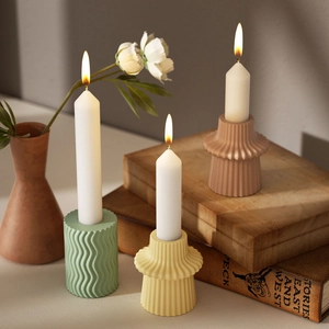 Detailed view of geometric striped candle holders in a warm lifestyle home setting