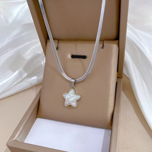 Detailed view of silver titanium steel star necklace with mermaid pearl inlay in gift box