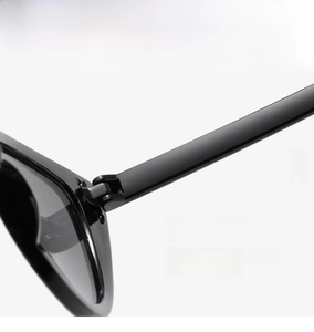 Detail shot of the sturdy metal hinge on black cat eye sunglasses for a smooth opening
