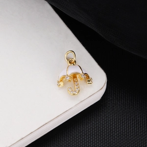Detail of 18K gold-plated umbrella pendant with white enamel and sparkling zircons