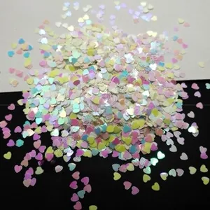 Detail of multi-colored heart shaped nail sequins with iridescent holographic finish
