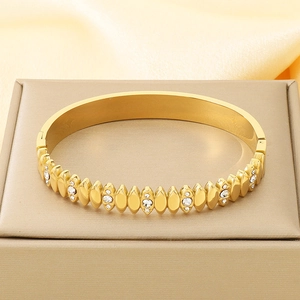 Detail view of 18K gold plated stainless steel hinge bracelet with white zircon stones