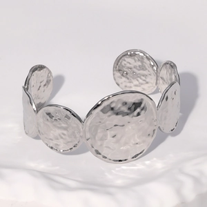 Silver stainless steel open cuff bracelet with artistic hammered texture discs