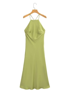 Detail of elegant olive green satin slip dress hanging on a wooden hanger against white backdrop