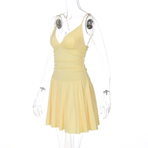 Detail of yellow V-neck camisole dress featuring ruched bodice and thin straps