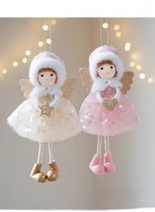Detail of Christmas angel ornaments with sequin tulle skirts and golden wings decoration