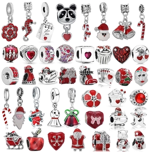 Detailed collection of red enamel Christmas charms featuring Santa and heart shapes