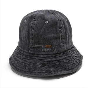 Detailed embroidery and leather patch on dark grey washed denim bucket hat