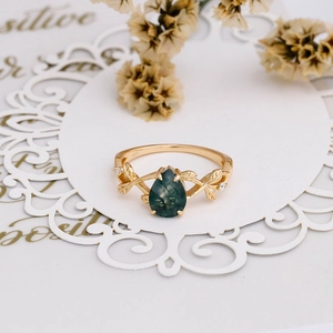 Detailed view of S925 silver vine ring featuring a pear-cut green moss agate and zircon
