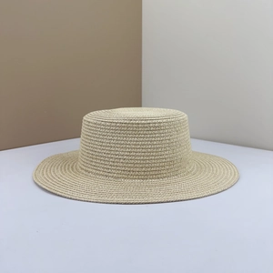 Close-up of a beige woven boater straw hat with fine texture on a geometric background