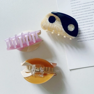 Set of three Yin Yang acetate claw clips in black, white, pink, and caramel marble patterns