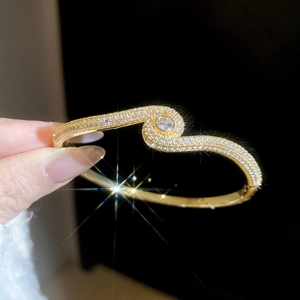 Detailed close-up of 18k gold plated bangle with sparkling cubic zirconia pavé setting
