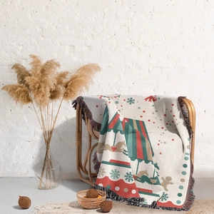 Detail of Christmas throw blanket with merry-go-round patterns and tassel fringe