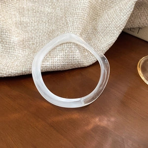 Detail showing wavy irregular white resin bracelet with a natural misty cloud texture