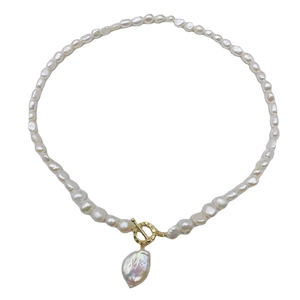 Elegant French baroque freshwater pearl necklace with golden OT clasp on white background