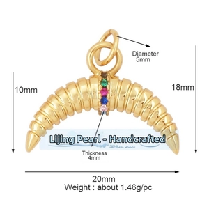 Detailed view of a gold horn-shaped pendant with five colorful inlaid gemstones