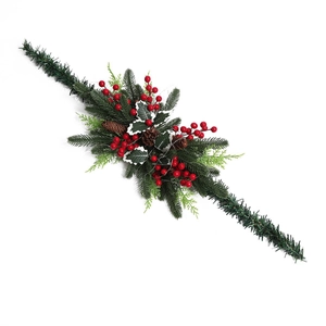 Close-up of festive Christmas garland featuring red berries, pine cones and holly leaves
