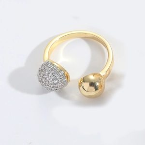 Detail of 18K gold open ring featuring one polished ball and one pavé zircon sphere