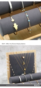 Macro detail of gold and silver bracelets on bamboo wood jewelry display stand