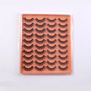 Close-up of 20 pairs of dense black DD curl false eyelashes in a peach-colored tray