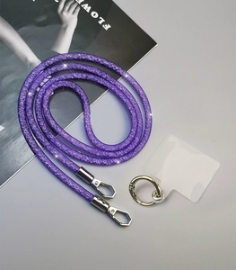 Detail view of purple rhinestone woven phone lanyard with metal clips and attachment tab