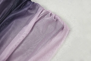 Close-up of purple gradient mesh fabric with fine pleated texture and soft color transition
