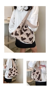Detailed knit texture of a beige and brown heart pattern crochet tote bag
