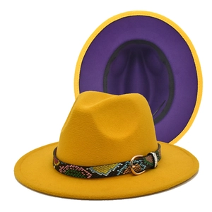 Detail of yellow fedora hat with purple lining and snakeskin band with golden buckle