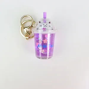 Purple milk tea cup keychain with liquid glitter sand and a cute white cat figure