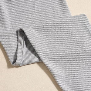 Close-up of grey ribbed knit fabric showing elastic texture and material thickness