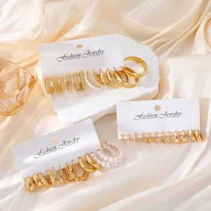 Chic 8-piece gold-tone earring set featuring geometric hoops and faux pearls on white cards