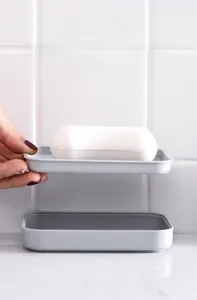 Close-up of a double-layer detachable soap holder with draining slots and a water tray