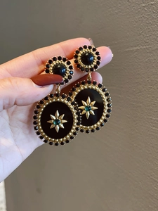 Detail view of vintage geometric floral earrings with gold plating and resin stones