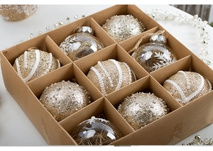 Detailed set of 9 champagne gold Christmas ornaments with beads in a kraft gift box