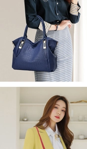 Detail of dark blue crocodile pattern handbag with golden hardware and fashion handle