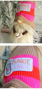 Detail of knitted gnome doll with Dunkie Junkie embroidery and coffee cup accessory