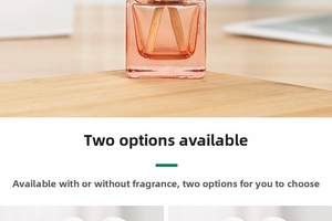 Close-up of pink square glass car perfume bottle with two wooden reed diffusers