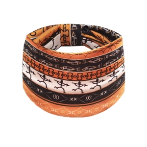 Bohemian stretch headband with African tribal print and geometric patterns in orange and black