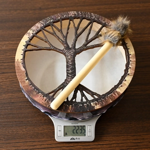 Detail view of handmade Tree of Life shaman drum on scales weighing 223.5 grams