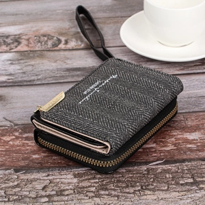 Detail of grey textured wallet with gold zipper and Forever Sunshine lettering on wood
