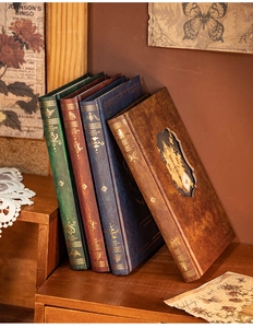 Detail of vintage hardcover journals with elegant gold foil embossing and classic patterns