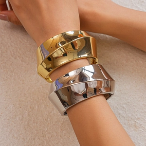 Polished gold and silver wide geometric cuff bracelets with bold asymmetric angular design