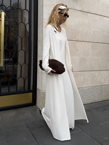 Detail of white knit maxi dress and long cardigan set featuring soft breathable fabric