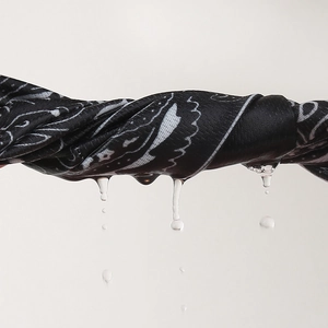 Detail showing the moisture-wicking technology on paisley bandana for outdoor sports