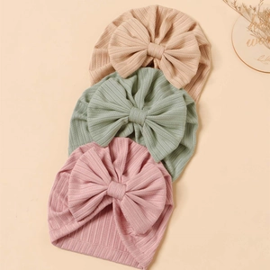 Three-piece baby turban hats in beige, sage, and dusty rose with large knit bows