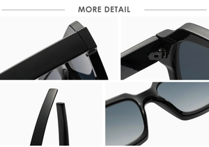Detail view of black sunglasses featuring metal hinges and gradient lenses