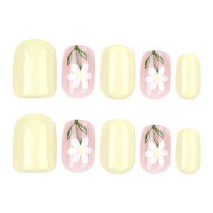 Short square press-on nails with daisy floral designs and soft pastel yellow finish