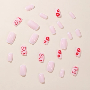 Valentine's Day press-on nails with red hearts, lip prints, and white French tips on nude base