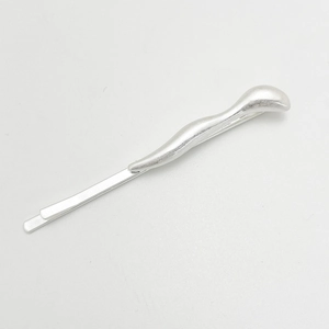 Detail view of silver irregular alloy hair clip with streamlined matte finish design